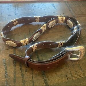 Western belt with rawhide/silver concho accents. Size 50.  1 1/2 inch width.